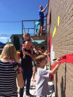 Residents help paint mural on Whiteland building